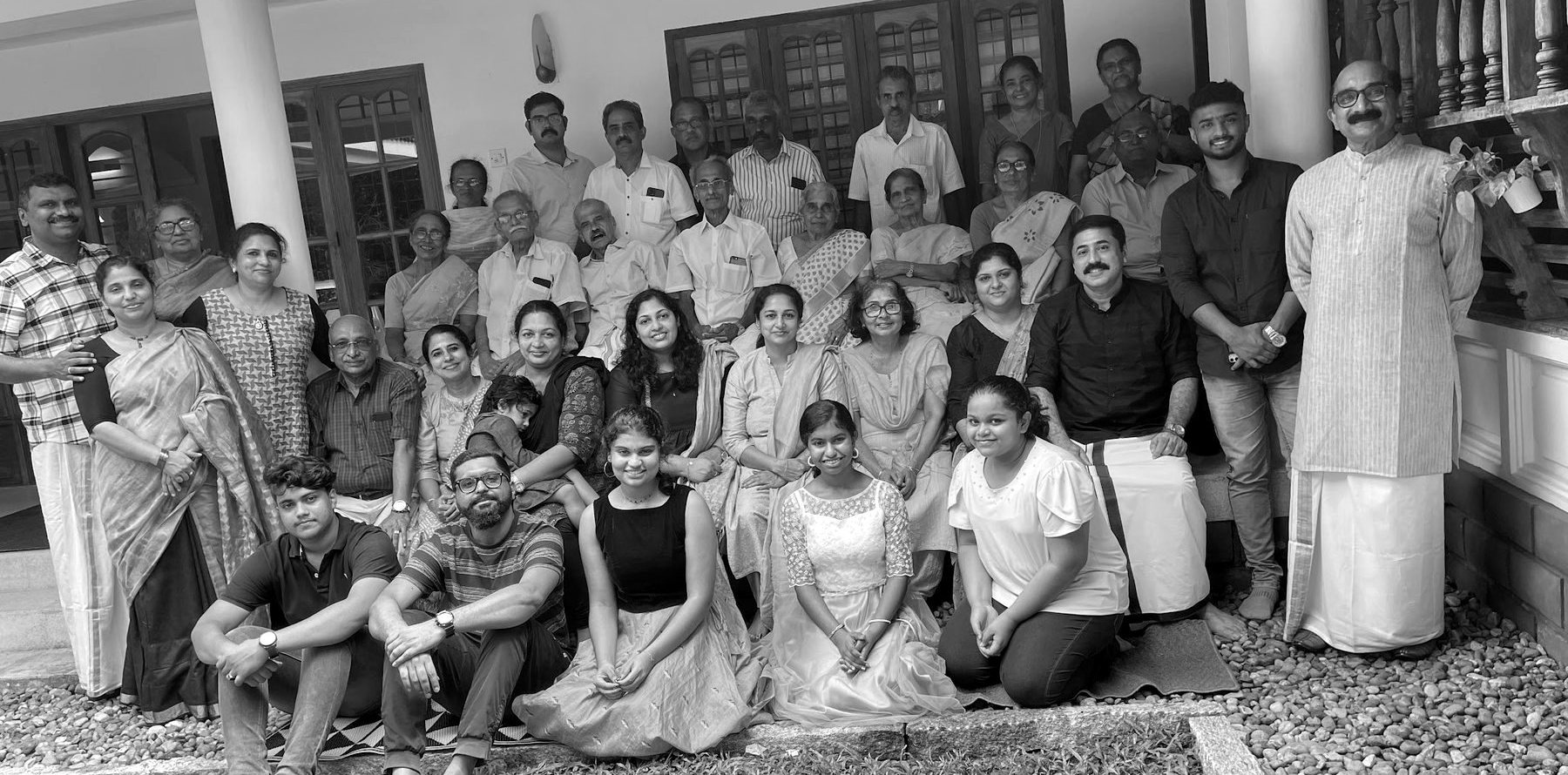 The extended family gathered on the verandah of the tharavadu